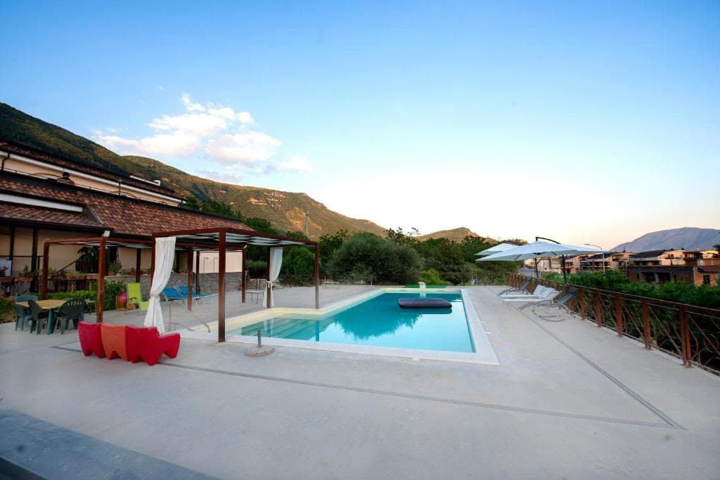 La piscina con gazebo, incorniciata dalle montagne