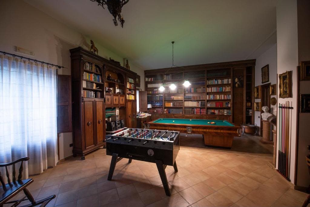 La sala giochi con biliardo, calcio balilla e la biblioteca storica della villa